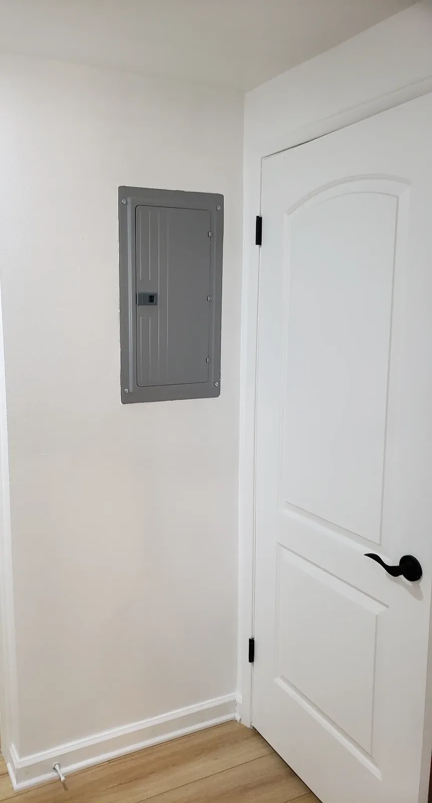 Finished residential electrical panel installed flush in an interior wall