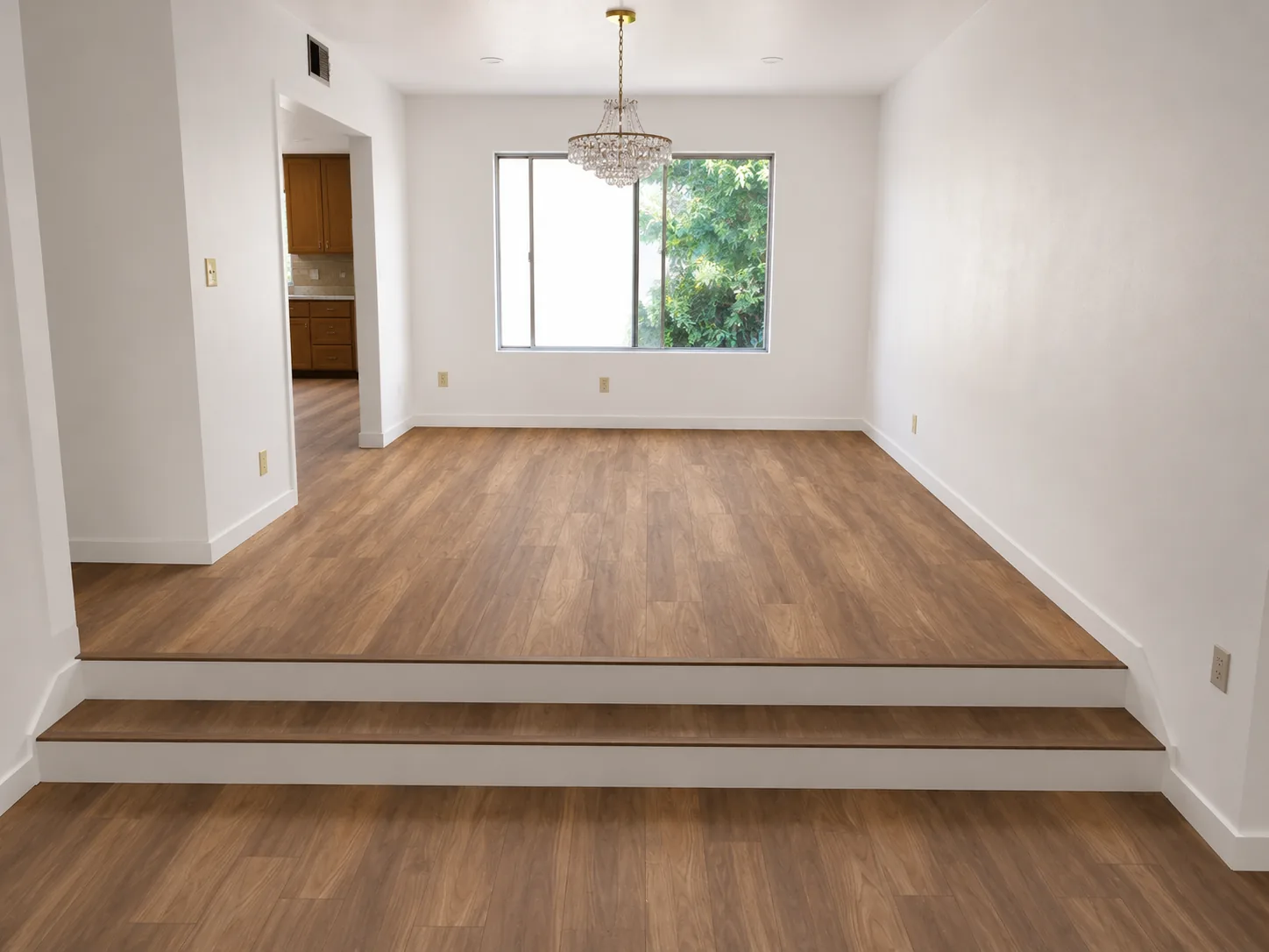 Wood flooring installation with two-step transition in a bright dining room