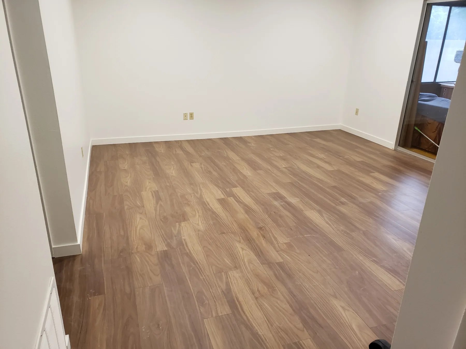 Finished wood flooring installation in an open interior room