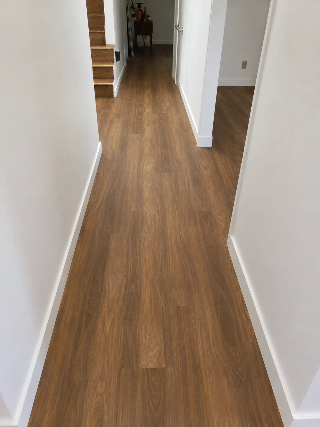 Wood flooring installation extending through a residential hallway